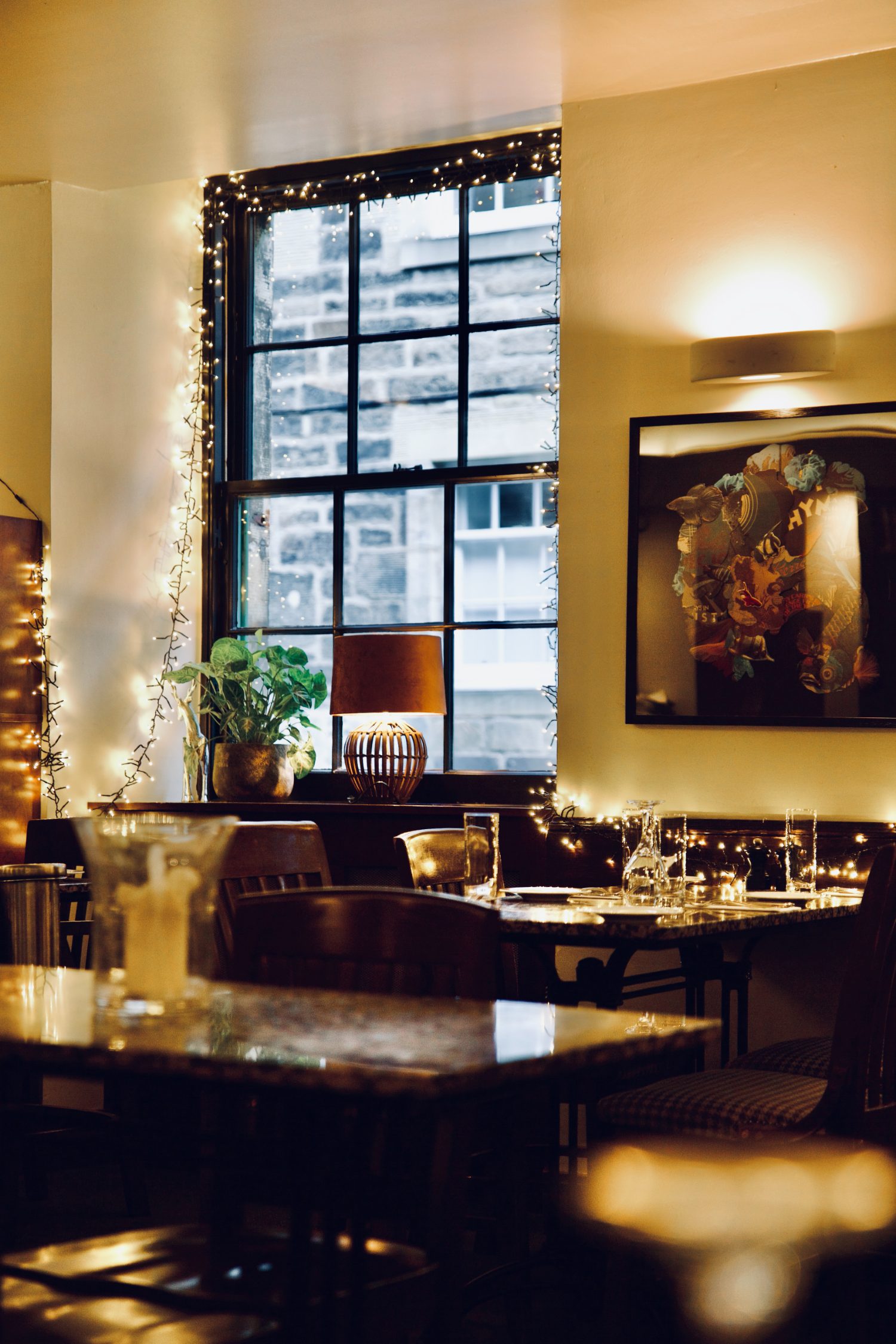 The dining room at dusk, fairy-lit windows