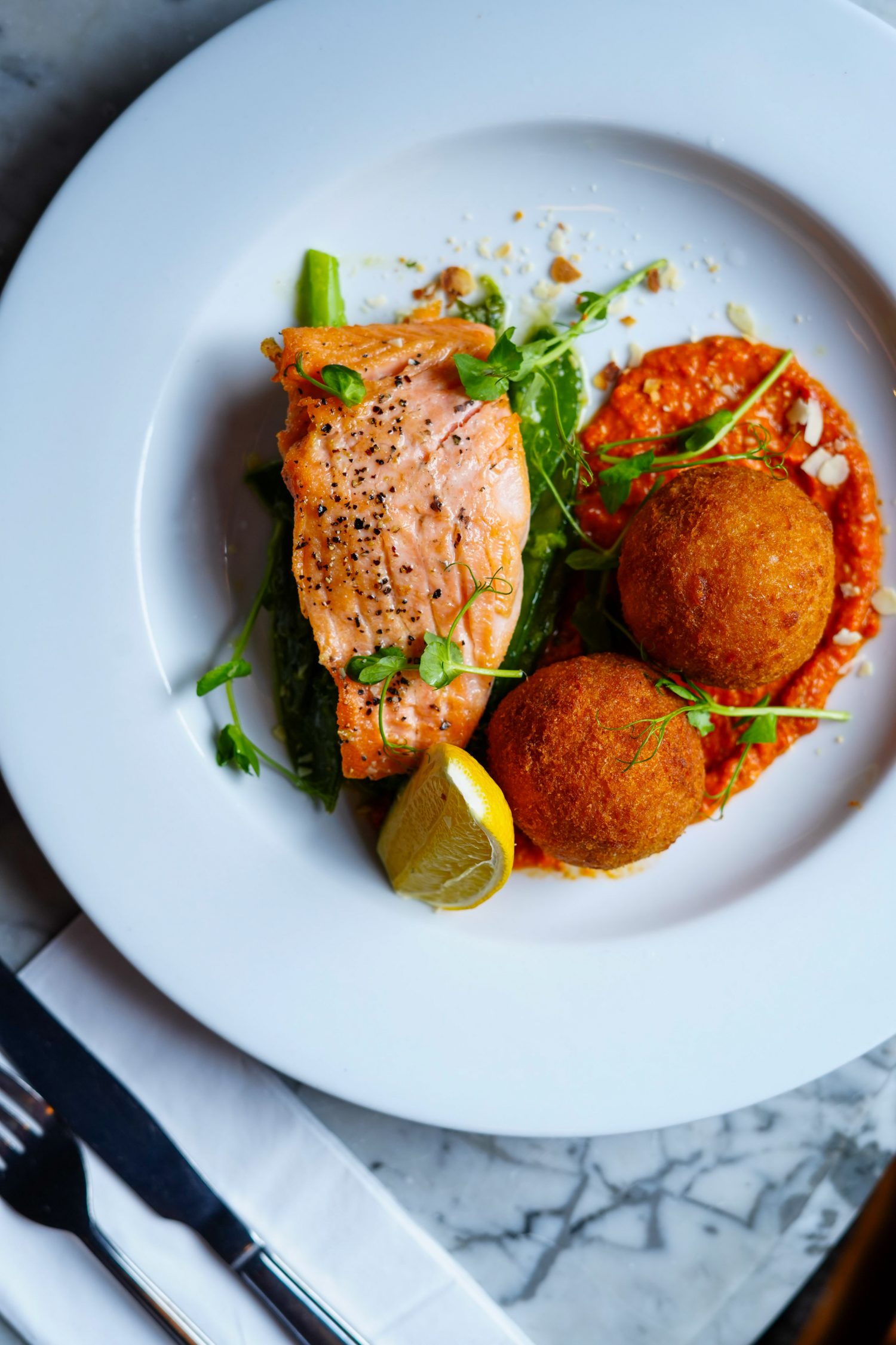 Salmon with arancini and romesco
